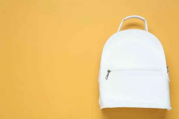 Stylish urban backpack on yellow background, top view. Space for text