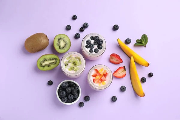 Jars Fresh Yogurt Different Fruits Lilac Background Flat Lay — Stockfoto