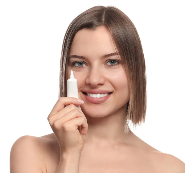 Young Woman Holding Tube Eye Cream White Background — Stok fotoğraf