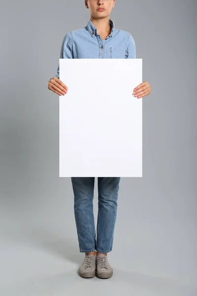 Woman Holding White Blank Poster Grey Background Closeup Mockup Design — Stock Photo, Image