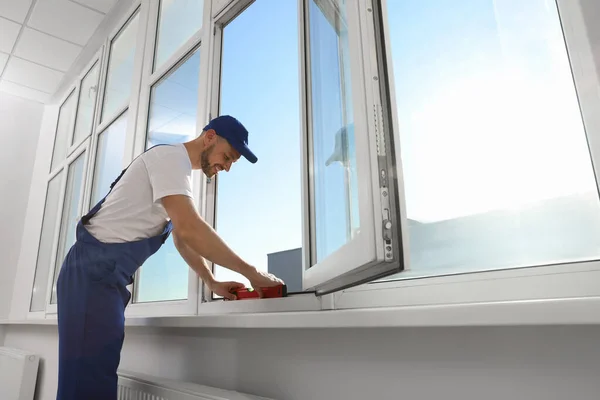 Worker Using Bubble Level Plastic Window Installation Indoors — Stock Fotó