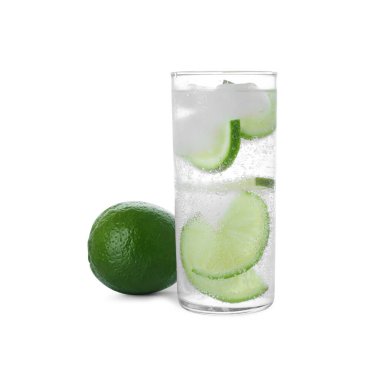 Glass with water, sliced lime and ice on white background