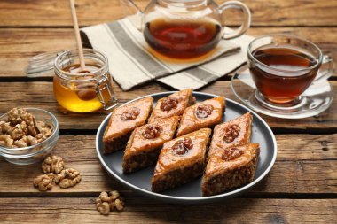 Cevizli, ballı ve ahşap masada sıcak çayla nefis bir baklava.