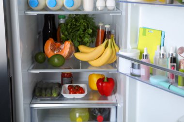 Storage of cosmetics in refrigerator door bin next to groceries