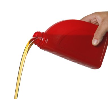 Man pouring motor oil from red container on white background, closeup