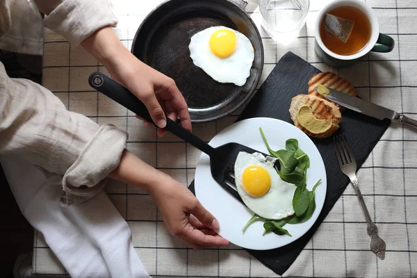 Woman Putting Tasty Fried Eggs Plate Table Top View — Stockfoto