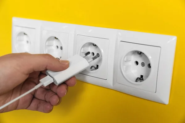 Woman Plugging Charger Power Socket Yellow Wall Closeup Electrical Supply — Foto de Stock