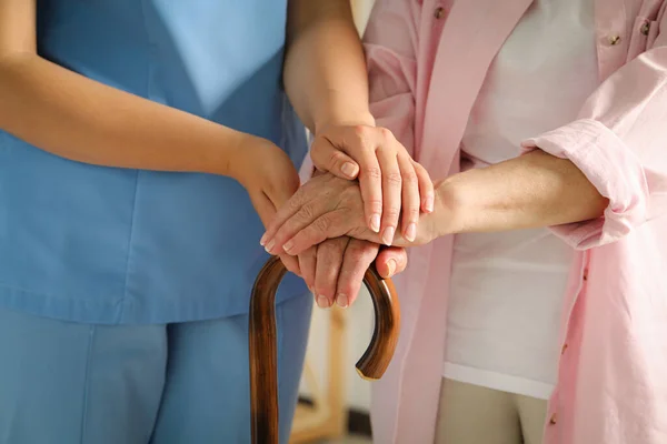 Elderly Woman Walking Cane Female Caregiver Indoors Closeup — Fotografia de Stock