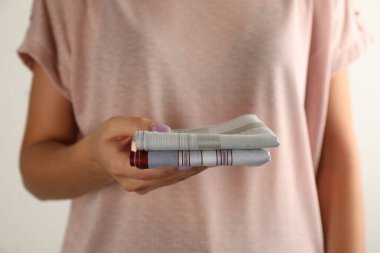Woman holding handkerchiefs on white background, closeup
