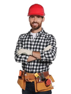 Professional builder in hard hat with tool belt isolated on white