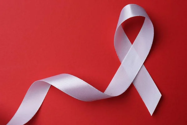 White Awareness Ribbon Red Background Top View Space Text — Stockfoto