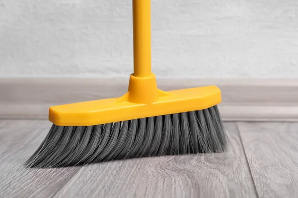 Sweeping Wooden Floor Plastic Broom Closeup — Stock Photo, Image