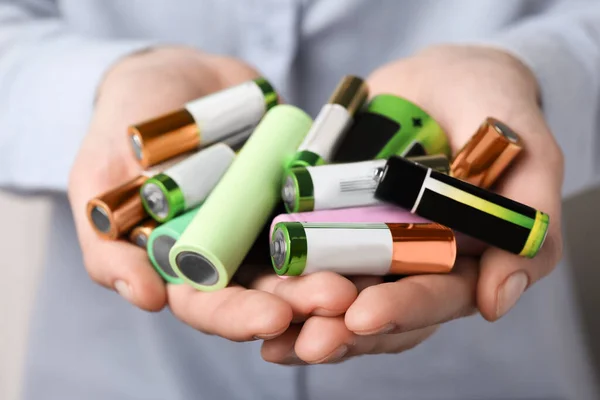 Woman Holding Many Used Electric Batteries Her Hands Closeup — Stockfoto