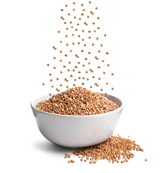 Raw Buckwheat Grains Falling Bowl White Background — Stockfoto