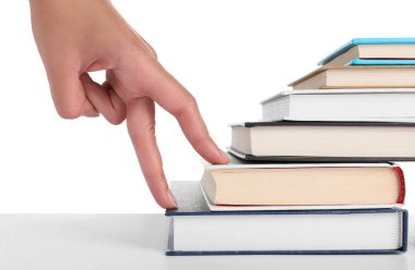 Woman imitating stepping up on books with her fingers against white background, closeup