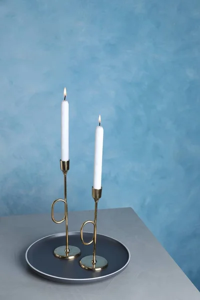 Holders Burning Candles Grey Table Light Blue Wall — Stockfoto