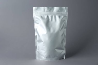 One blank foil package on grey background