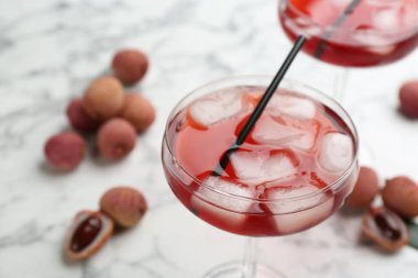 Delicious lychee cocktail in glass on table, closeup