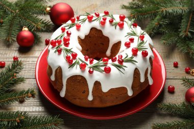 Composition with traditional Christmas cake and decorations on wooden table