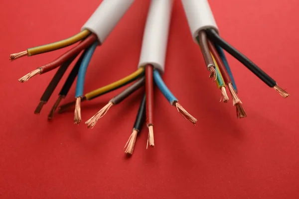 Electric Cables Wires Red Background Closeup View — Zdjęcie stockowe