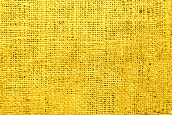 Texture of yellow burlap fabric as background, top view