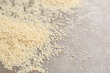 Sesame seeds on grey marble table, closeup