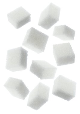 Flying cubes of sugar on white background