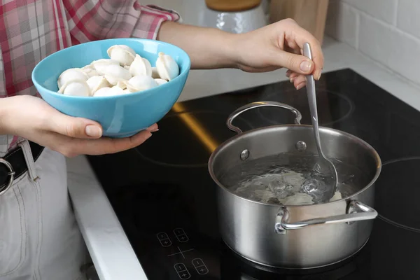 Woman Putting Frozen Dumplings Saucepan Boiling Water Cooktop Kitchen Closeup — Stockfoto