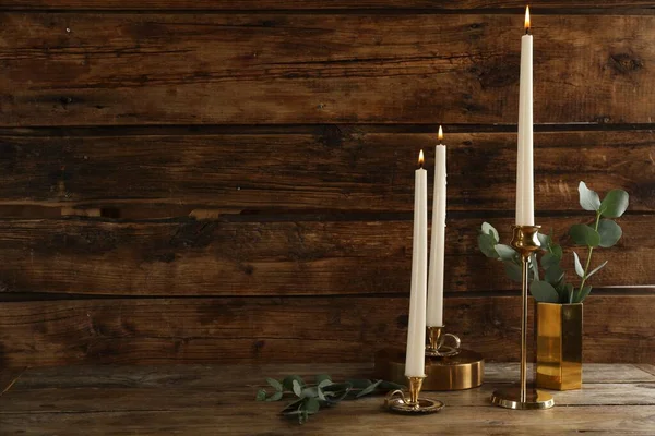 Elegant Candlesticks Burning Candles Eucalyptus Wooden Table Space Text — 스톡 사진