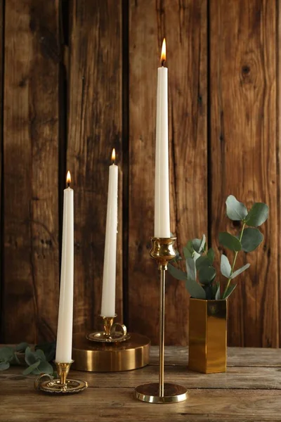 Elegant Candlesticks Burning Candles Eucalyptus Wooden Table — Stock Fotó