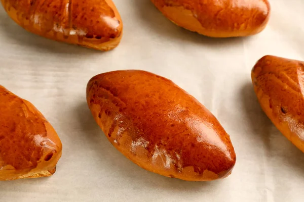 Delicious Baked Pirozhki Parchment Paper Closeup — Stockfoto