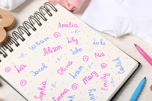 Caderno Com Diferentes Nomes Bebê Itens Criança Mesa Madeira Branca — Fotografia de Stock