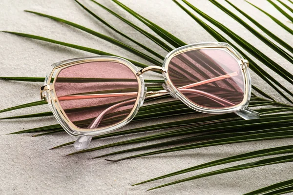 Stylish Sunglasses Palm Leaf Sand View — Stockfoto