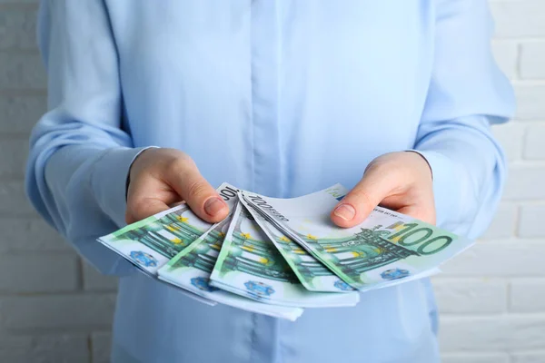 Woman Holding 100 Euro Banknotes White Brick Wall Closeup Money — Stock fotografie