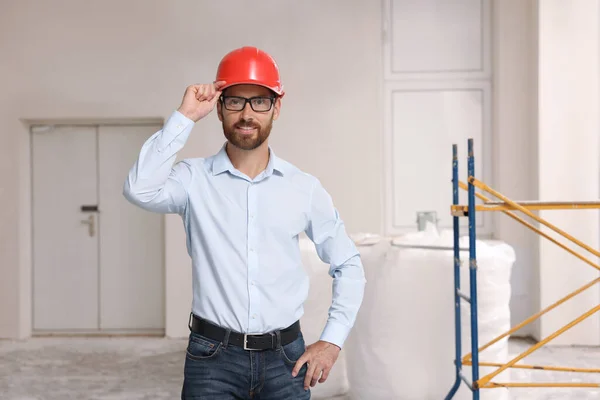 Portrait of professional engineer in hard hat indoors