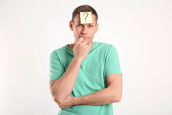 Thoughtful man with question mark on white background