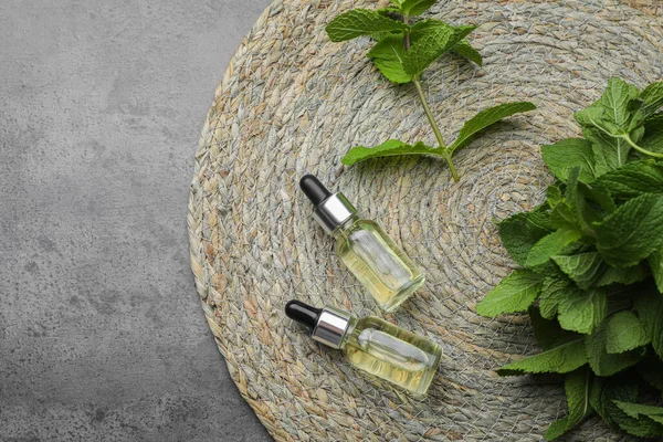 Bottles Essential Oil Mint Grey Table Top View Space Text — Stockfoto