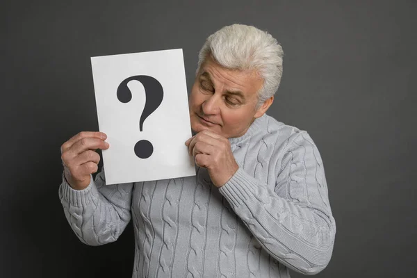 Emotional Mature Man Holding Paper Question Mark Dark Grey Background — ストック写真