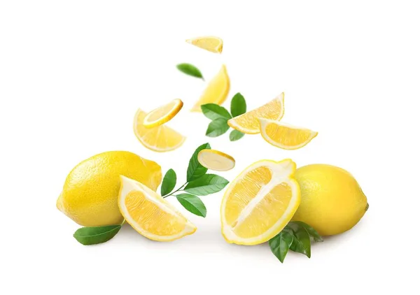 Fresh Ripe Lemons Green Leaves Falling White Background — Stock fotografie