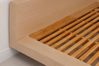 Closeup view of new wooden bed frame indoors