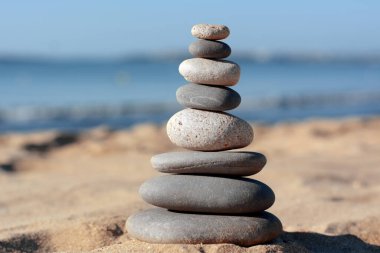 Stack of stones on beautiful sandy beach