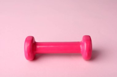 One color dumbbell on light pink background