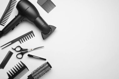 Flat lay composition with modern hair dryer on white background, space for text