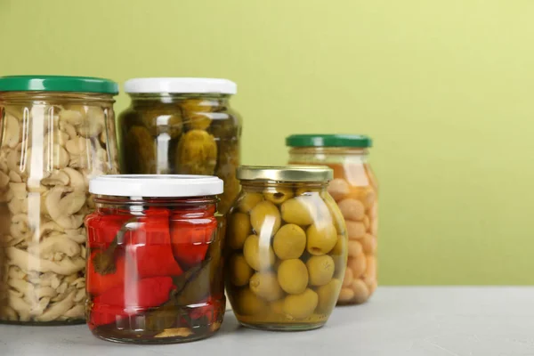 Jars of pickled vegetables on light table