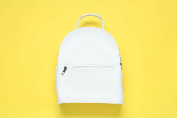 Stylish urban backpack on yellow background, top view