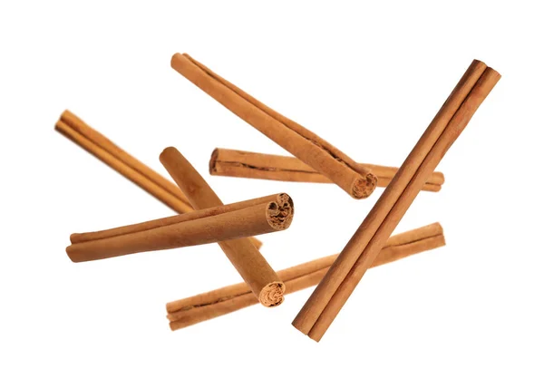 Aromatic Dry Cinnamon Sticks Falling White Background — Foto Stock