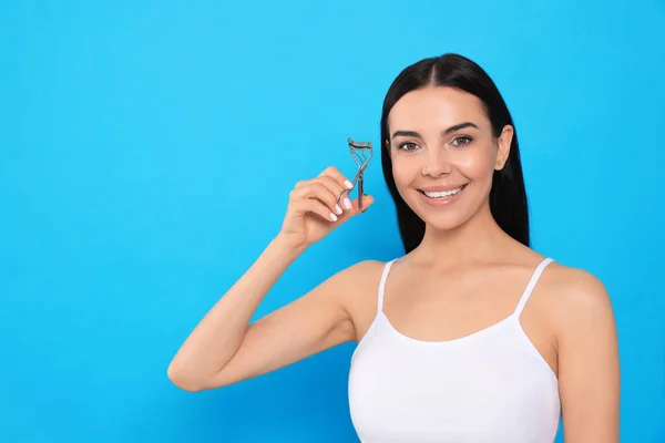 Beautiful Young Woman Eyelash Curler Light Blue Background Space Text — Stockfoto
