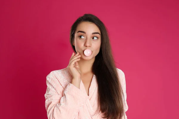 Young Woman Bathrobe Blowing Chewing Gum Crimson Background — Stock Photo, Image