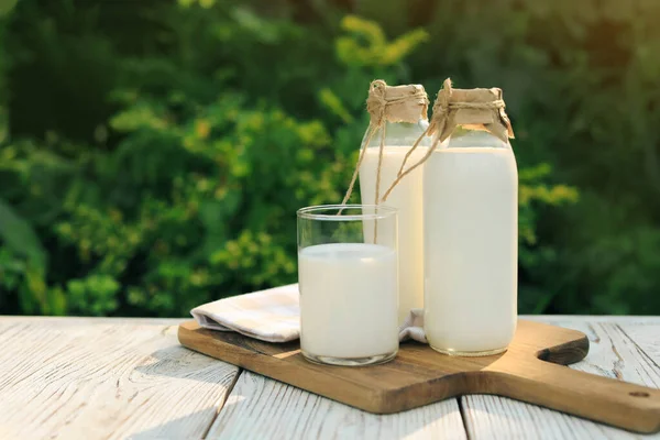 Bottles Glass Tasty Fresh Milk White Wooden Table Outdoors Space — Foto Stock