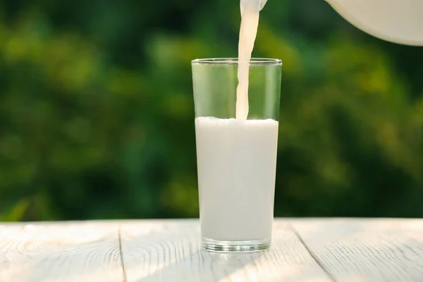 Pouring Tasty Fresh Milk Glass White Wooden Table Closeup Space — Stock Photo, Image